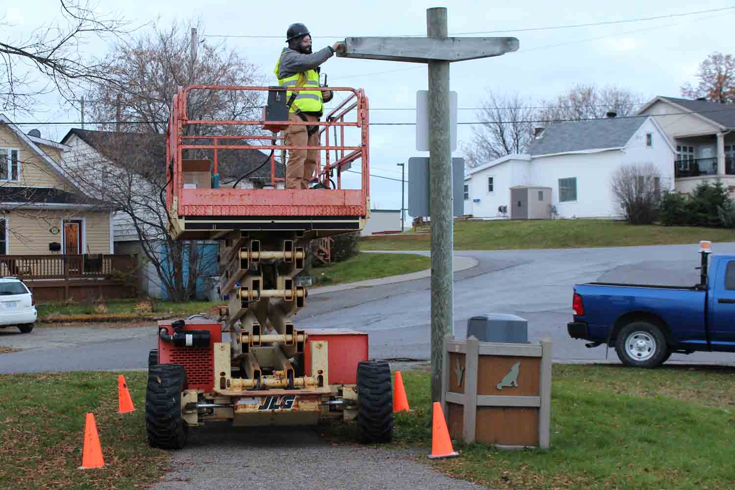 Worker installing LED lights in outdoor lightposts